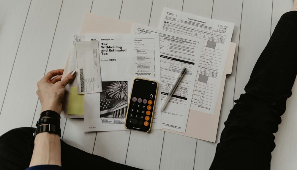 Tax forms and a calculator on a desk